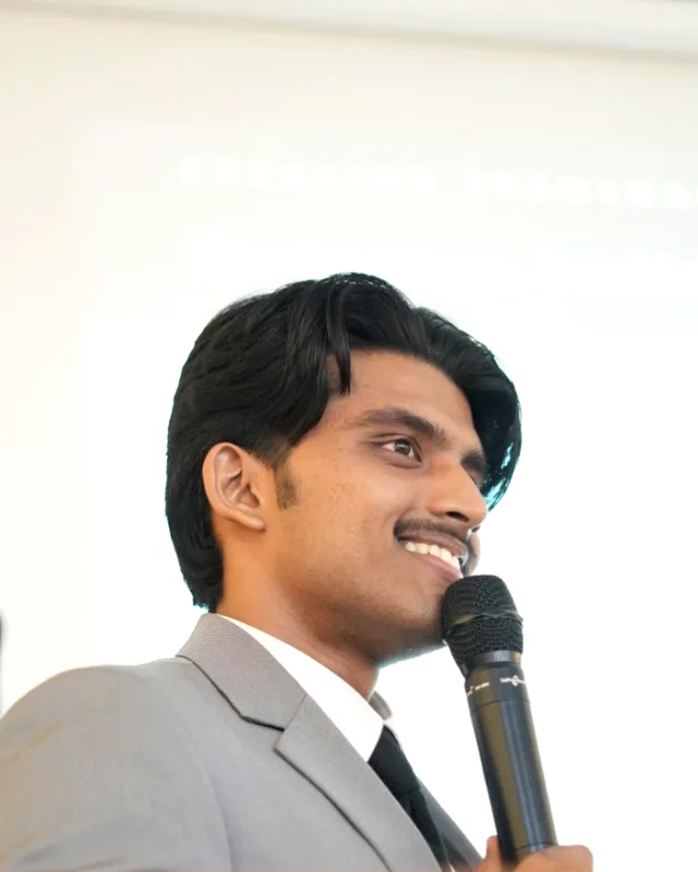 Jonah Joy laughing mid-sentence while speaking at an event